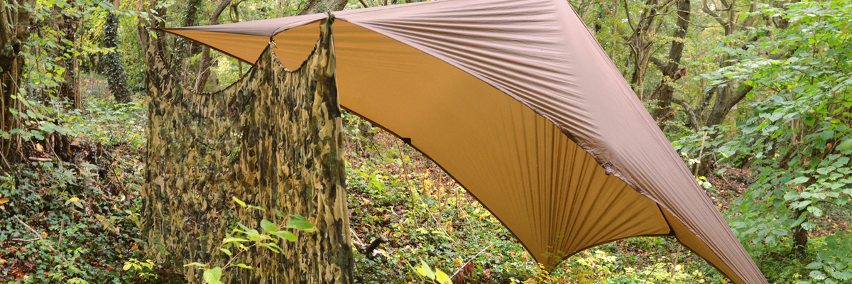 A luxury hotel room including a large bed and sofa with doors out onto the plains
